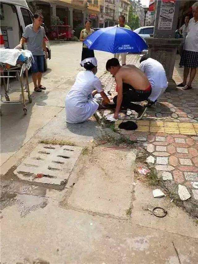 摩托车司机躺在地上,头部受到撞击受伤流血.