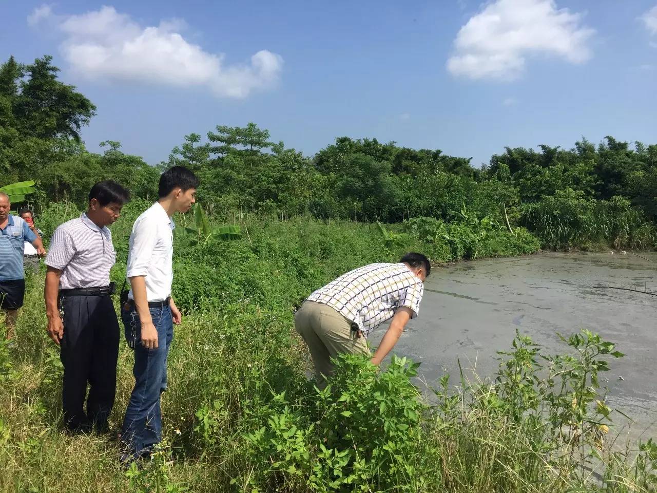 (环保局工作人员查看污染地)